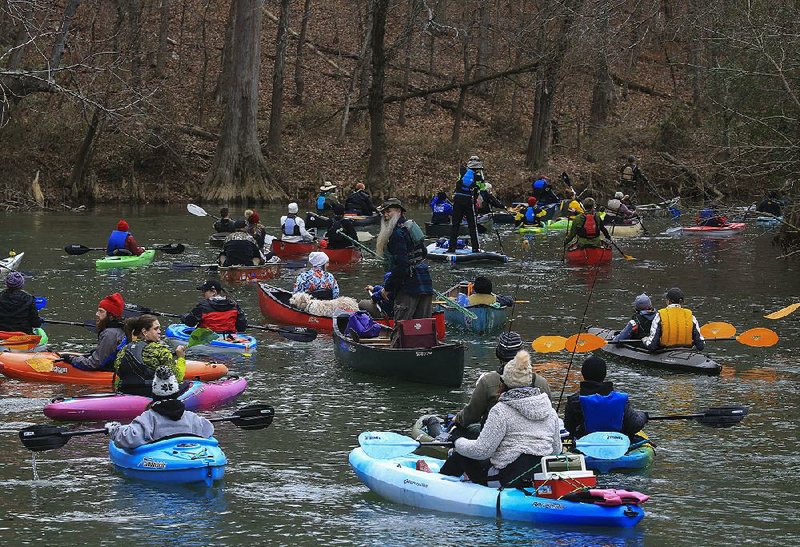 Paddlers, including Patrick Cuffel, standing, set off Wednesday Jan. 1, 2020 on a New Year's Day float from the boat ramp on the Little Maumelle River at Pinnacle Mountain State Park. The float was organized by the Arkansas Canoe Club and Arkansas Water Trails Partnership.  See more photos at arkansasonline.com/12float/. (Arkansas Democrat-Gazette/Staton Breidenthal)  