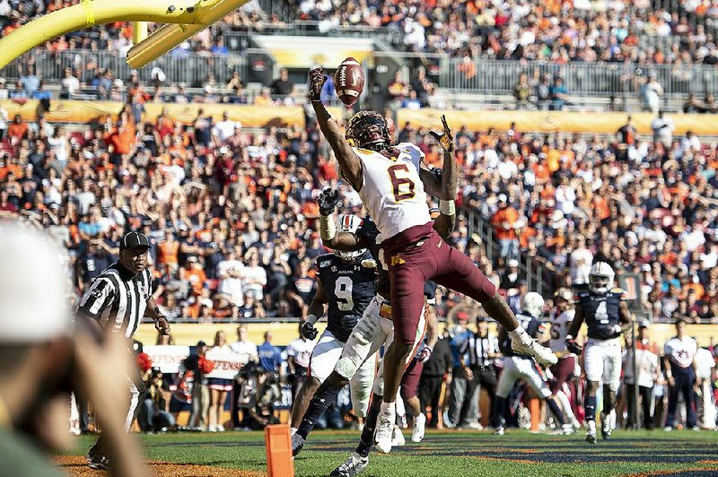 Wide receiver Tyler Johnson (6) reaches for a pass that he caught for a touchdown late in the second quarter as No. 18 Minnesota beat No. 12 Auburn 31-24 at the Outback Bowl in Tampa, Fla. Johnson had 12 receptions for 204 yards and 2 touchdowns to become the Gophers’ career receiving leader.
(AP/Star Tribune/ Aaron Lavinsky)