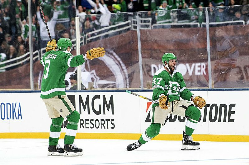 Dallas right wing Alexander Radulov (right) celebrates his tie-breaking goal with defenseman John Klingberg during the third period of the Stars’ 4-2 victory over the Nashville Predators on Wednesday in the NHL Winter Classic at the Cotton Bowl in Dallas.
(AP/Jeffrey McWhorter)