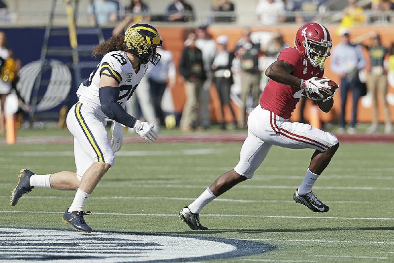 Alabama receiver Jerry Jeudy (right) was named the Citrus Bowl MVP on Wednesday after catching six passes for 204 yards and a touchdown. His 85-yard touchdown reception from Mac Jones came on the game’s first play of the Tide’s 35-16 victory over Michigan.
(AP/John Raoux)