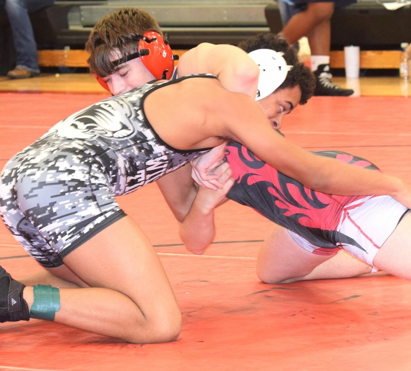 RICK PECK/SPECIAL TO MCDONALD COUNTY PRESS McDonald County's Coty Dumond and William Collier of Willard square off in a 145-pound match at the Sixth Annual Cal Willie JV Wrestling Tournament on Dec. 21 at MCHS. Collier won the bout with a pin late in the first period.