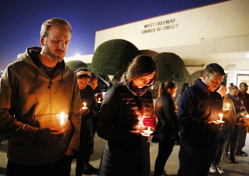Church and community members, including Matt Pacholczyk (left) and his wife, Faith Pacholczyk, stand outside West Freeway Church of Christ for a candlelight vigil in White Settlement, Texas, on Monday. The machete attack on a rabbi’s home in Monsey, N.Y., during Hanukkah and the shooting of worshippers at a Texas church are refocusing attention on how vulnerable worshippers are during religious services. FBI hate crime statistics show there is reason for concern.
(The Dallas Morning News via AP/Tom Fox)