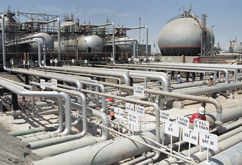 FILE - In this file photo dated 1990, Aramco refinery at Ras Tannura, Saudi Arabia. The price of oil surged Friday Jan. 3, 2020, as global investors were gripped with uncertainty over the potential repercussions and any retaliation, after the United States killed Iran's top general Qassem Soleimani.(AP Photo/FILE)

