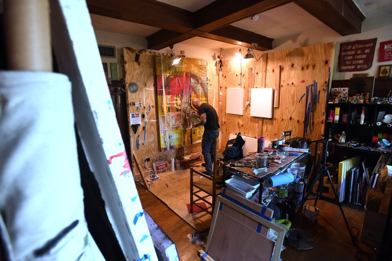 NWA Democrat-Gazette/J.T. WAMPLER Jody Travis Thompson of Fayetteville paints Oct. 17 in his studio. "There are certain types of art that are sort of interventions into society," Thompson said. "Words can get really combative. Art has this amazing, magical ability to just let somebody quietly observe."