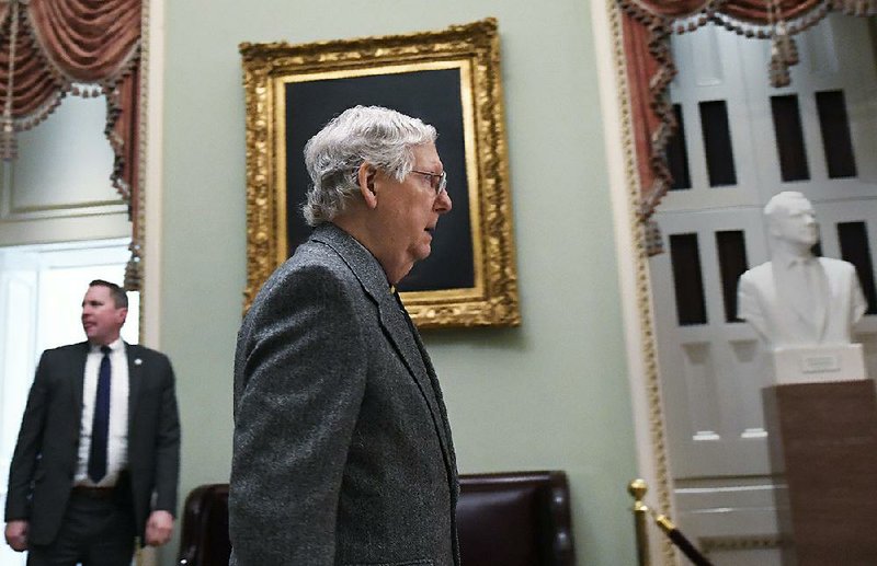 Senate Majority Leader Mitch McConnell arrives Friday on Capitol Hill. In a speech on the Senate floor, he said GOP senators would be “content to continue the ordinary business of the Senate while House Democrats continue to flounder.” More photos at arkansasonline.com/14impeachment/.  