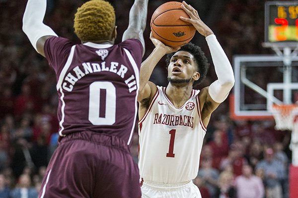 Arkansas guard Isaiah Joe (1) shoots against Texas A&M defender Jay Jay Chandler during a game Saturday, Jan. 4, 2020, in Fayetteville. 