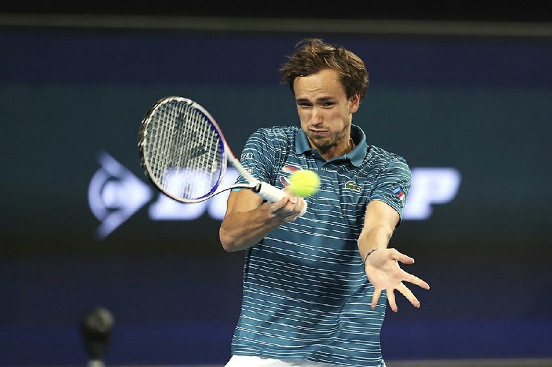 Russsia’s Daniil Medvedev retuns the ball to John Isner of the United States during their ATP Cup match Sunday in Perth, Australia. Medvedev won 6-3, 6-1 to give Russia two victories in Group D and keep the United States winless. 