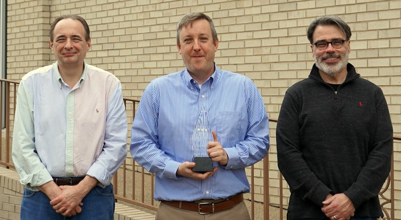 Staff writer David Showers, center, displays the 2019 Journalist of the Year Award for The Sentinel-Record staff recently at the newspaper. With Showers is General Manager Harry Porter, right, and Mark Gregory, editor. - Photo by Cassidy Kendall of The Sentinel-Record