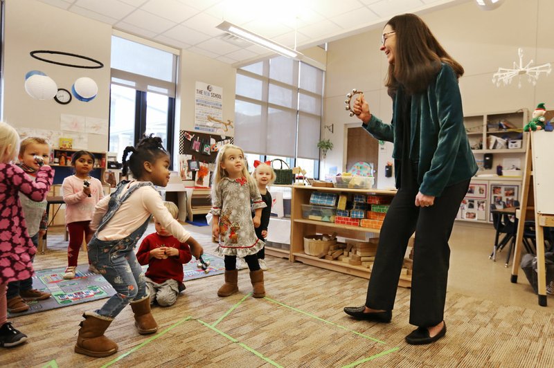 NWA Arkansas Democrat-Gazette/DAVID GOTTSCHALK Nancy Lang, head of school at The New School, sings a Christmas carol Dec. 21 with students at the Fayetteville school. Lang received her bachelor's degree from Cornell University, then spent about three years in the Air Force before moving into education.