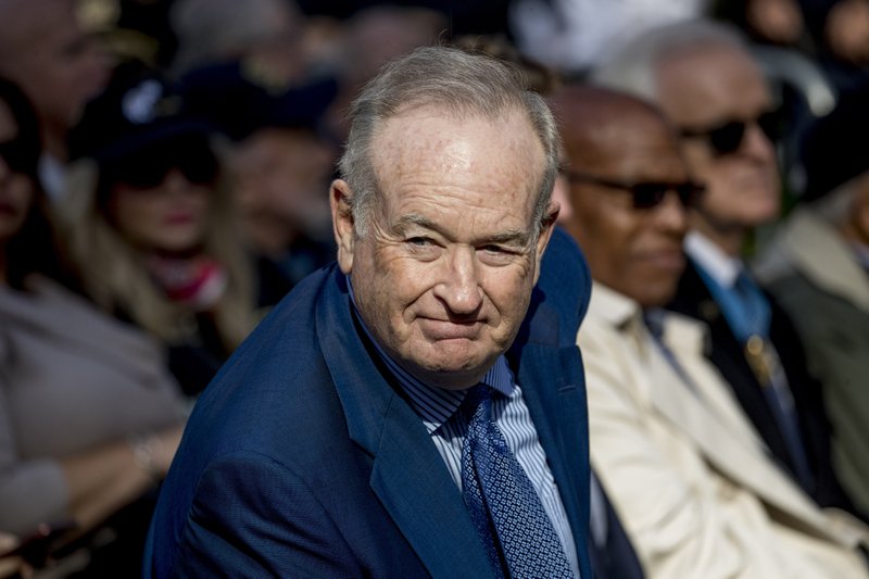 FILE - In this Nov. 11, 2019, file photo, Bill O'Reilly, right, arrives before President Donald Trump and first lady Melania Trump participate in a wreath laying ceremony at the New York City Veterans Day Parade at Madison Square Park in New York. The Discovery Channel says a television show featuring O&#x2019;Reilly is not an official program on their network after receiving backlash for the former Fox News host's appearance on the show amid sexual harassment allegations against him. (AP Photo/Andrew Harnik, File)