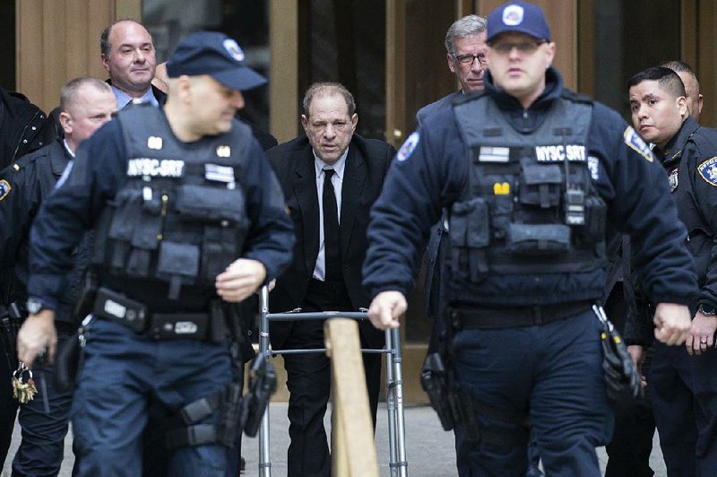 Court officers surround Harvey Weinstein on Monday as he leaves a pretrial hearing in New York. More photos at arkansasonline.com/17weinstein/