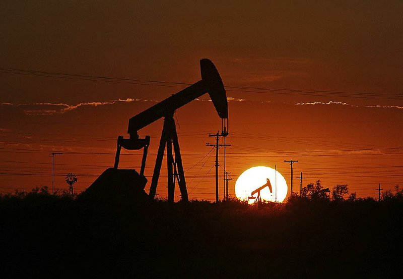 A pump jack operates last summer in an oil field in the Permian Basin in Texas.