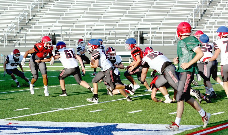 MARK HUMPHREY ENTERPRISE-LEADER Farmington's 2019 varsity scrimmaged during the annual Red and White game played for the first time on Thursday, Aug. 15, 2019, at Cardinal Stadium during an open house showcasing the $16 million facilities to the public.