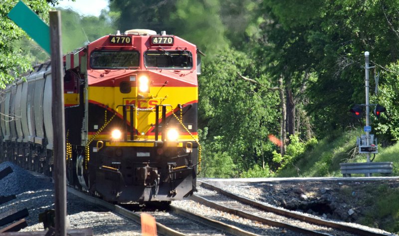 Westside Eagle Observer/MIKE ECKELS A northbound Kansas City Southern grain train crosses over the Third Street crossing in Decatur May 14, 2019, on its way back to Kansas City. Typically northbound trains like this one operate at speeds of between 20-30 miles an hour since they are running down the Decatur grade.