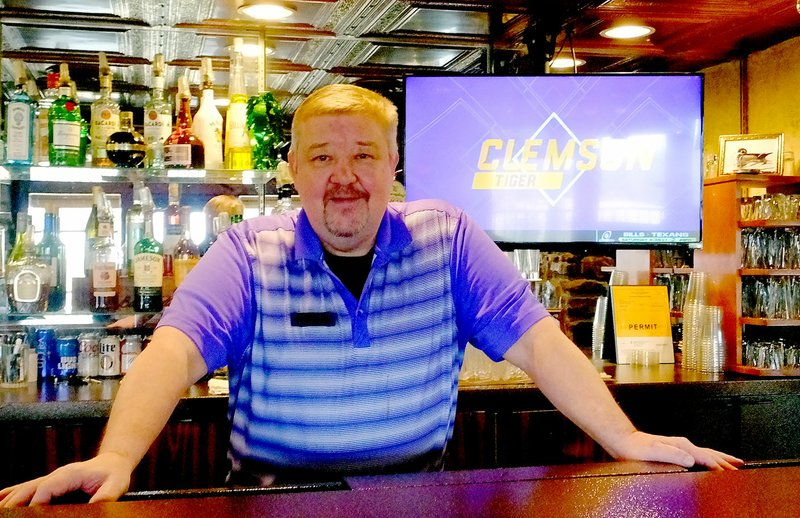 Lynn Atkins/The Weekly Vista Bill McCleary, the bartender at the Highlands Pub, takes pride in knowing many of his customers by name. The Pub's winter hours are 3 to 7 p.m., Tuesday through Friday.