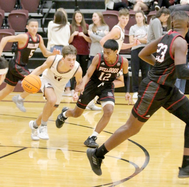 Mark Ross/Special to the Herald-Leader Siloam Springs senior guard Evan Sauer brings the ball up the floor against Springdale on Saturday in the Siloam Springs Holiday Classic.