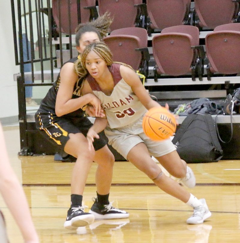 Mark Ross/Special to the Herald-Leader Siloam Springs senior Jael Harried drives around a Prairie Grove defender on Saturday in the championship of the Siloam Springs Holiday Classic.