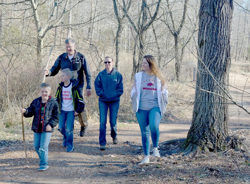 Keith Bryant/The Weekly Vista Lukas Wilhelm, 7, leads Nate Wilhelm, 8, Andrew Wilhelm, Karen Hunt and Lexie Wilhelm on Tweety Bird, a trail near Chelsea Road among the freshly-opened 14 miles of central trails.