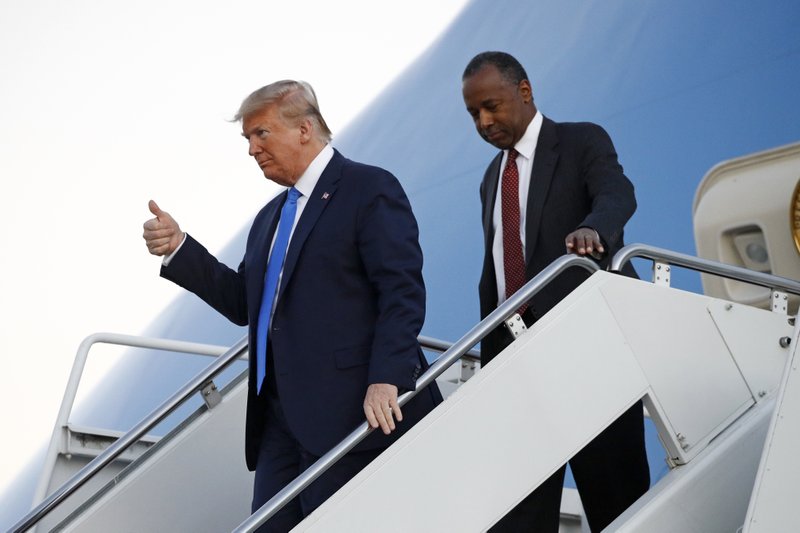President Donald Trump and Housing and Urban Development Secretary Ben Carson step off Air Force One at Fort Lauderdale-Hollywood International Airport in Fort Lauderdale, Fla., Saturday, Dec. 7, 2019, to attend a Republican fundraiser and speak at the Israeli American Council National Summit. 
(AP Photo/Patrick Semansky)