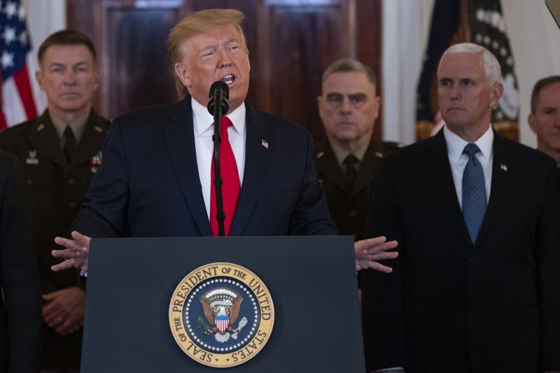 President Donald Trump addresses the nation from the White House on the ballistic missile strike that Iran launched against Iraqi air bases housing U.S. troops, Wednesday, Jan. 8, 2020, in Washington, as Vice President Mike Pence, Secretary of State Mike Pompeo and military leaders, looks on. (AP Photo/Alex Brandon)

