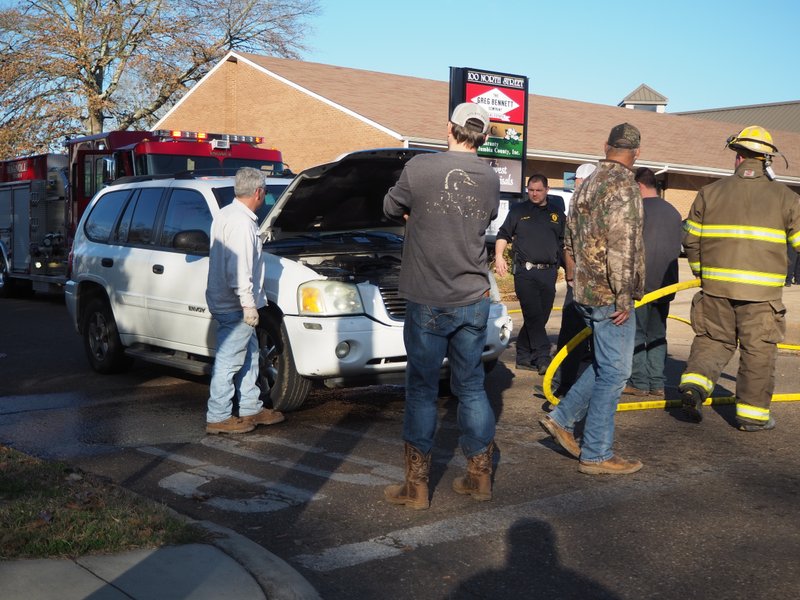 Magnolia Fire Department and Magnolia Police Department personnel surround a white GMC Envoy that briefly caused an emergency call Wednesday afternoon at the corner of Washington and North Street, located just off the north side Magnolia's square.  