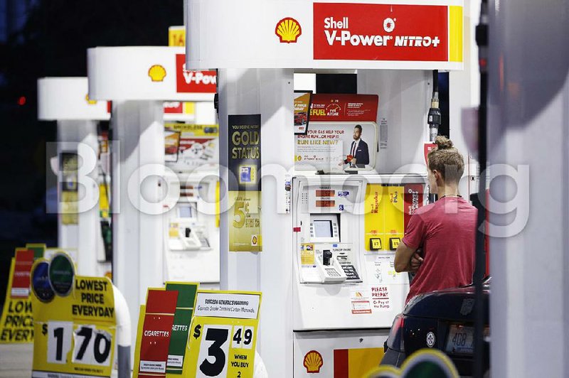 A customer fuels up at a Shell station in Louisville, Ky., last June. Gas stations face an Oct. 1 deadline to install chip card readers on fuel pumps.
(Bloomberg News/Luke Sharrett)