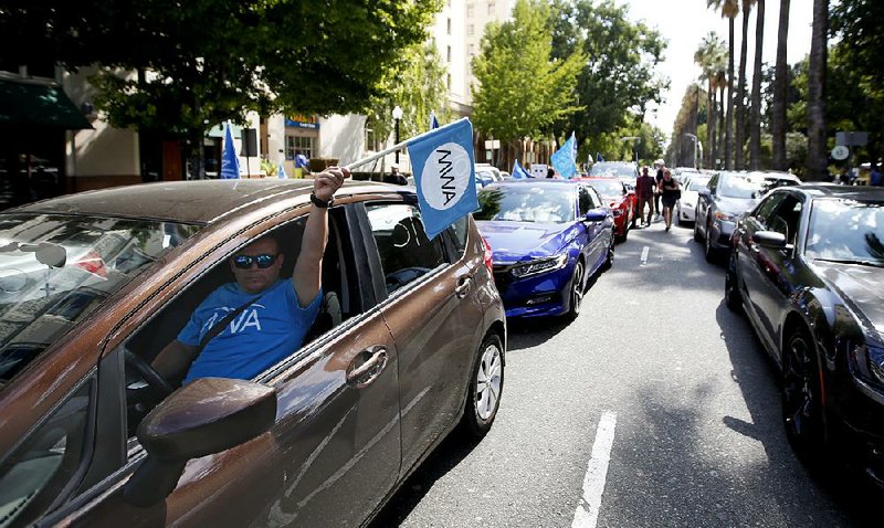 Supporters of a measure to limit when companies can label workers as independent contractors rally near the state Capitol in Sacramento, Calif., in August. Ride-share company Uber and meal delivery service Postmates have sued to block enforcement of the law, which took effect Jan. 1.
(AP/Rich Pedroncelli)