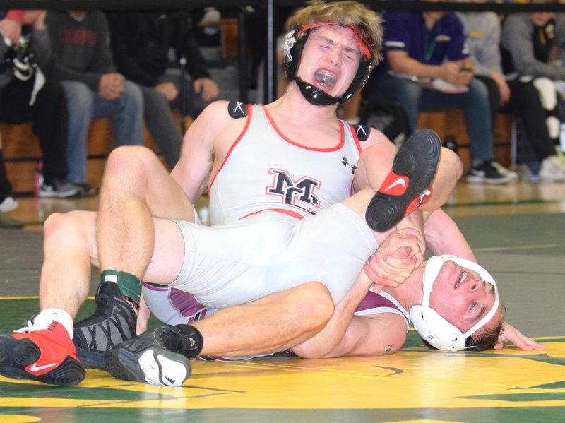 RICK PECK/SPECIAL TO MCDONALD COUNTY PRESS McDonald County's Oscar Ortiz tries to get Zach Fennel of Rolla to his back in the 132-pound championship match at the Kinloch Classic held Jan. 3-4 at Parkview High School in Springfield. Ortiz won the match with a 5-2 decision.