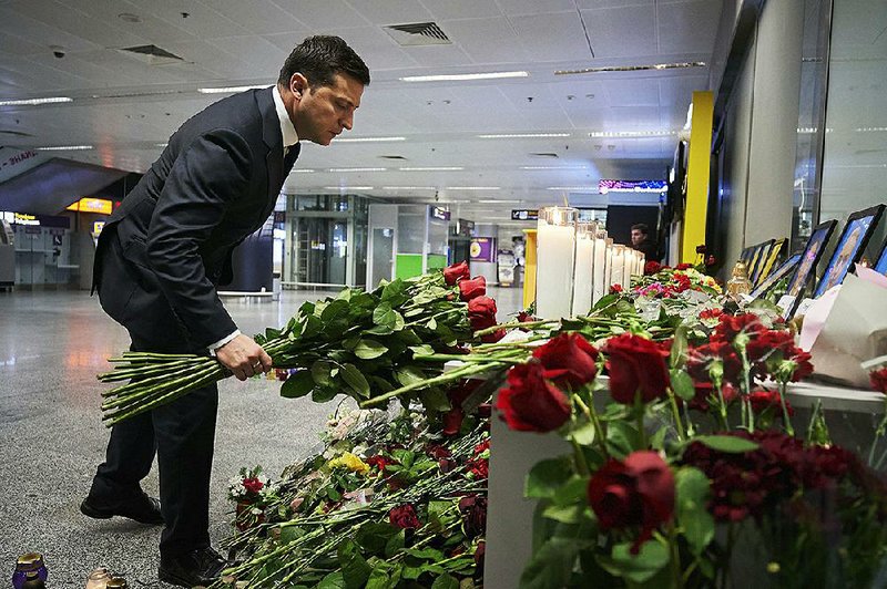 Ukrainian President Volodymyr Zelenskiy places flowers at a memorial for crash victims Thursday at the airport outside Kyiv, Ukraine. “Undoubtedly, the priority for Ukraine is to identify the causes of the plane crash,” Zelenskiy said. “We will surely find out the truth.” More photos at arkansasonline.com/110ukraine/.