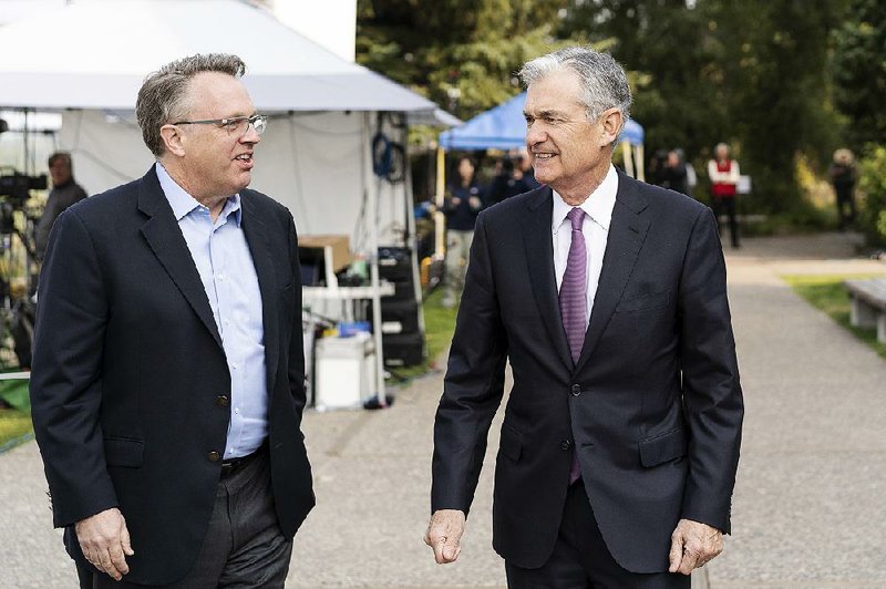 New York Federal Reserve Bank President John Williams (left) speaks with Fed Chairman Jerome Powell in 2018. Williams said Thursday that low interest rates are likely to be a persistent issue for years and cautioned against letting rates get too low.  