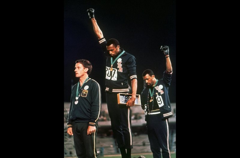 U.S. athletes Tommie Smith, center, and John Carlos raise their gloved fists after Smith received the gold and Carlos the bronze for the 200 meter run at the Summer Olympic Games in Mexico City on Oct. 16, 1968. The International Olympic Committee published guidelines Thursday specifying which types of athlete protests will not be allowed at the 2020 Tokyo Games. Athletes are prohibited by the Olympic Charter's Rule 50 from taking a political stand in the field of play -- like the raised fists by American sprinters Tommie Smith and John Carlos at the 1968 Mexico City Games. - Associated Press file photo