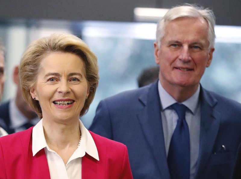 European Commission President Ursula Von der Leyen, foreground, and European Commission's Head of Task Force for Relations with the United Kingdom Michel Barnier arrive at the London School of Economics in London, Wednesday, Jan. 8, 2020. The European Commission's president warned Britain on Wednesday that it won&#x2019;t get the &#x201c;highest quality access&#x201d; to the European Union's market after Brexit unless it makes major compromises. (AP Photo/Frank Augstein)