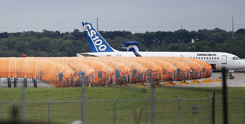 Completed Boeing 737 Max fuselages, made at Spirit AeroSystems in Wichita, Kan., sit covered in tarps near the factory in October. Citing “ongoing uncertainty” involving the grounded 737 Max, the airplane parts supplier announced Friday that it is laying off 2,800 employees at the Wichita facility.