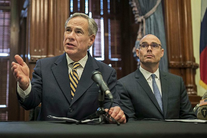 Gov. Greg Abbott, (left) shown in June, said Friday that his state has done “more than its share” in the settlement of refugees. 