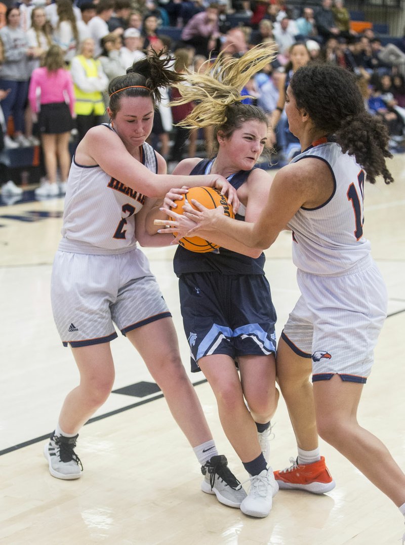 Lanee Knight (2) and Quiara Jones (10) of Rogers Heritage try to get the ball from Maddux McCrackin of Springdale Har-Ber Friday, Jan. 10, 2020, at War Eagle Arena in Rogers. Go to nwaonline.com/photos to see more photos. (NWA Democrat-Gazette/Ben Goff)