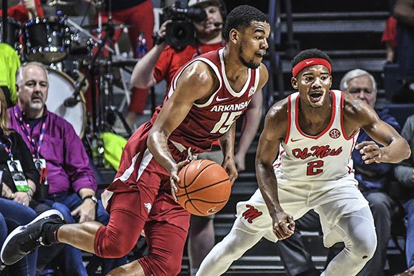 Arkansas guard Mason Jones (15) is defended by Ole Miss guard Devontae Shuler (2) during an NCAA college basketball game Saturday, Jan. 11, 2020, in Oxford, Miss. (Bruce Newman/The Oxford Eagle via AP)