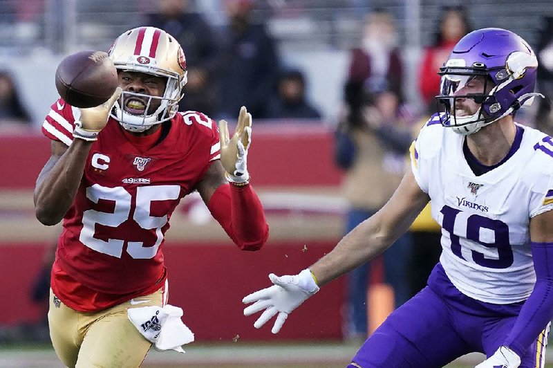 San Francisco 49ers cornerback Richard Sherman (left) intercepts a pass in front of Minnesota Vikings wide receiver Adam Thielen during the 49ers’ victory over the Vikings in the NFC divisional playoffs Saturday in Santa Clara, Calif.
