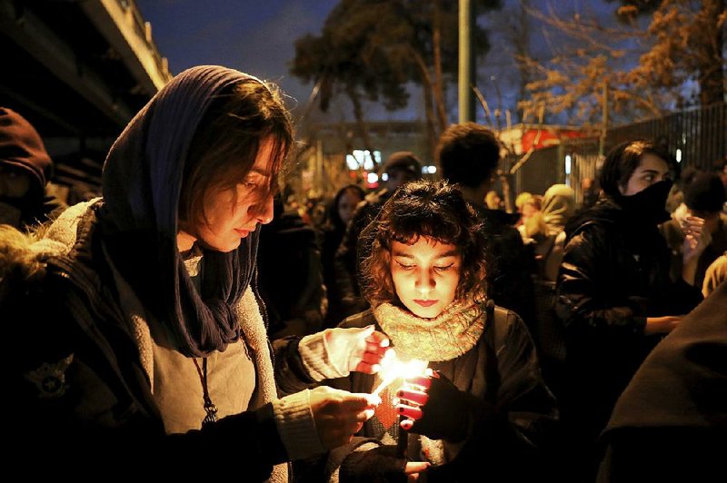 Iranians hold a vigil that turned into a protest Saturday at Amri Kabir University in Tehran for victims of the Ukrainian jet crash. Some of the dead had attended the university. More photos at arkansasonline.com/112crash/. 