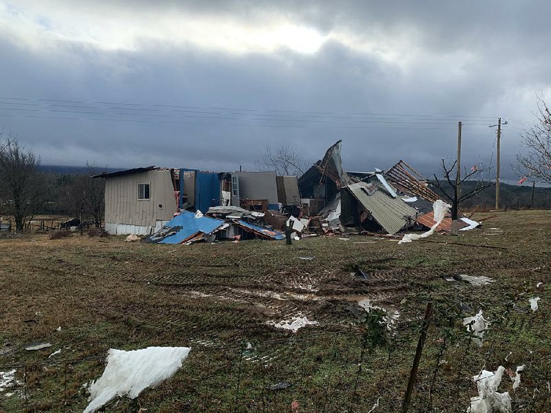 A home on Old Military Road in Midway sits in ruin Saturday after an EF-2 tornado struck in Logan County late Friday.  