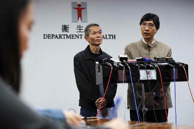 Hong Kong health official Wong Ka-hing (left) and University of Hong Kong disease expert Yuen Kwok-yung discuss the coronavirus Saturday in Hong Kong. Yuen said it is unclear if the virus can further change to become more lethal, noting that Hong Kong has a robust system for detecting more severe problems among patients. 