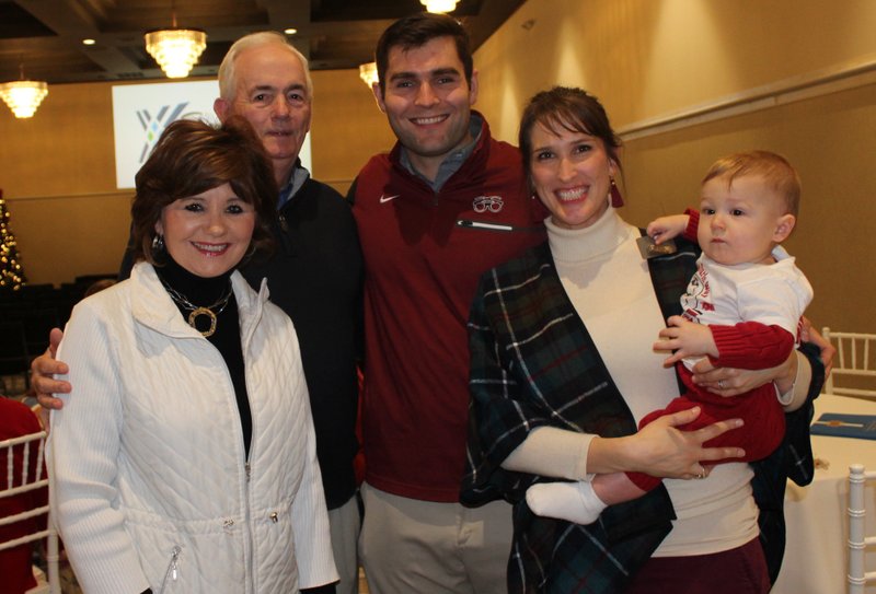 Jo Ann and Tommy Tice (from left) and Sean and Gentry Bedford, with Bowen Bedford, visit at the Burlsworth Foundation reception. (NWA Democrat-Gazette/Carin Schoppmeyer)