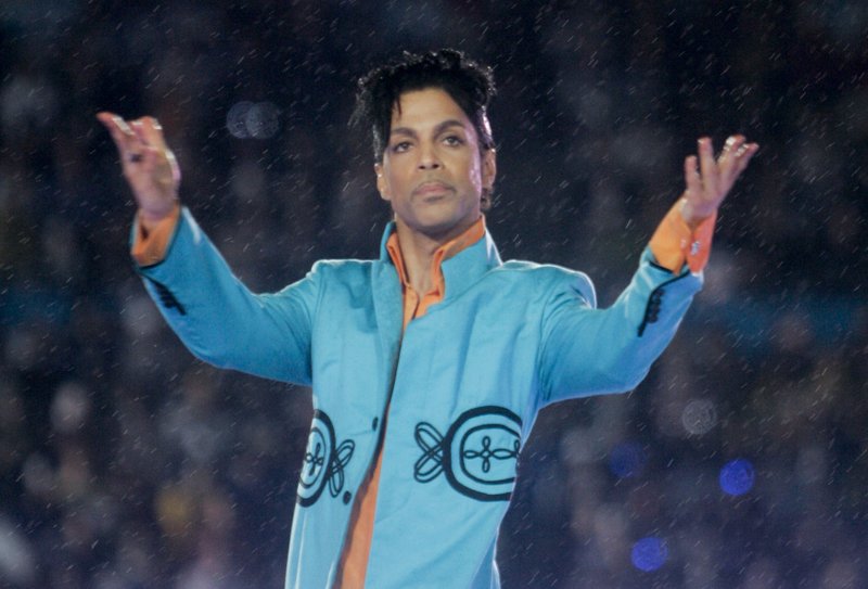 FILE - This Feb. 4, 2007 file photo shows Prince performing during the halftime show at the Super Bowl XLI football game at Dolphin Stadium in Miami. John Legend, Foo Fighters, Alicia Keys, Chris Martin, H.E.R. and Earth, Wind &amp; Fire are set to perform at a Prince tribute concert this month. The Recording Academy announced Thursday that &quot;Let's Go Crazy: The GRAMMY Salute to Prince&#x201d; will tape at the Los Angeles Convention Center on Jan. 28, two days after the 62nd annual Grammy Awards. Prince died on April 21, 2016. (AP Photo/David J. Phillip, File)