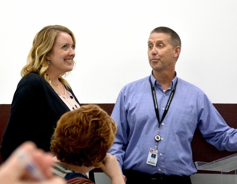 Janelle Jessen/Siloam Sunday High school principal Rob Lindley (right) recognized choir director Julianna Tufts during Thursday's school board meeting for recently being named Arkansas Choral Directors Association Region 6 choir director of the year. Region 6 includes schools such as Rogers, Harrison, Mountain Home, Bentonville, Pea Ridge, Decatur, Flippin and Siloam Springs, he said. Tufts came to Siloam Springs in 2014 and in 2016 the high school had three choirs and 90 students. Since then, Tufts has grown the choral program to five choirs and 190 students and her choirs have consistently had a superior rating, the highest possible, at regional and state assessments, Lindley said.