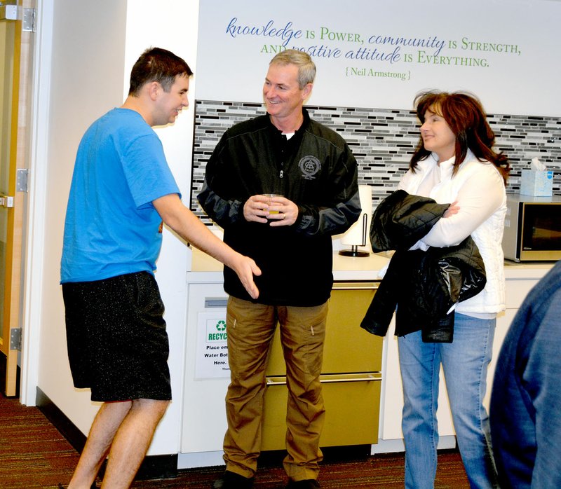 Marc Hayot/Siloam Sunday Sawyer Henson (left), greets new Siloam Springs Police Chief Allan Gilbert and his wife Brenda during a meet-and-greet event at the Siloam Springs Public Library on Wednesday.