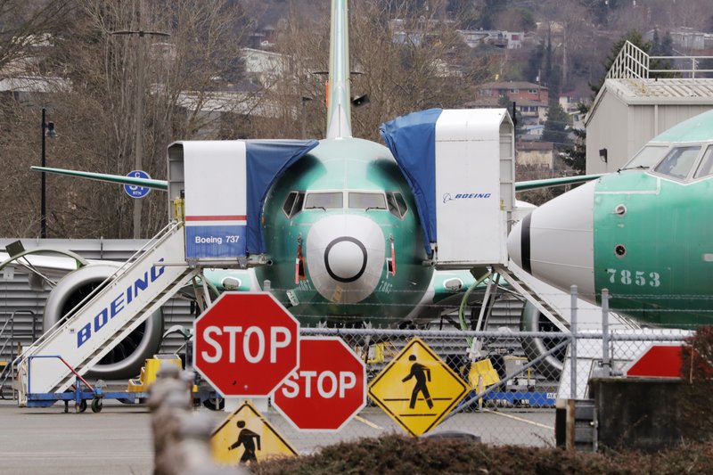 In this Dec. 16, 2019, file photo, Boeing 737 Max jets sit parked in Renton, Wash. Newly released Boeing documents show that company employees knew about problems with flight simulators for the now-grounded 737 Max jetliner and talked about misleading regulators. - AP Photo/Elaine Thompson