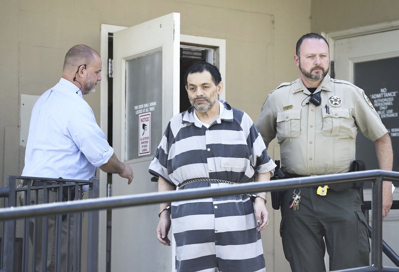 Mauricio Torres is escorted June 21 from the Benton County Courthouse Annex in Bentonville. (File Photo/NWA Democrat-Gazette/CHARLIE KAIJO)