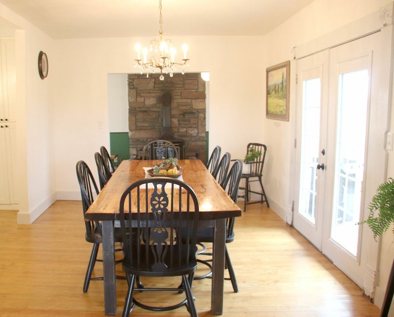 LYNN KUTTER ENTERPRISE-LEADER The dining room table for Farmhouse on the Hill is made from a pecan tree that fell on the property. The French doors lead to an outside patio with a firepit and a place for guests to gather.