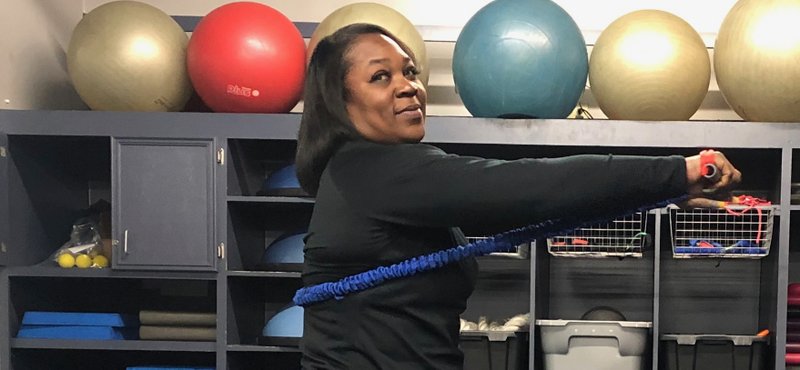 Mavis Pryor of Little Rock Racquet Club demonstrates the Burpee to Standing Chest Press exercise. (Arkansas Democrat-Gazette/Celia Storey 1/8/20)