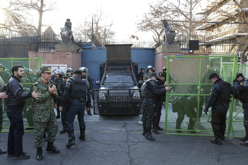 Police guard the British Embassy during an anti-UK protest in Tehran, Iran, on Sunday. Dozens of hard-liners later gathered outside the embassy on Sunday, chanting "Death to England" and calling for the ambassador to be expelled and for the closure of the embassy after the British ambassador was briefly arrested on Saturday. A candlelight ceremony late Saturday in Tehran turned into a protest, with hundreds of people chanting against the country's leaders -- including Supreme Leader Ayatollah Ali Khamenei -- and police dispersing them with tear gas. Police briefly detained the British ambassador to Iran, Rob Macaire, who said he went to the Saturday vigil without knowing it would turn into a protest. - AP Photo/Ebrahim Noroozi