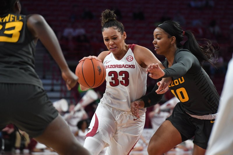 Arkansas' Chelsea Dungee drives to the basket while Missouri's Nadia Green defends Sunday at Bud Walton Arena in Fayetteville. The Hogs won 90-73. Photo by J.T. Wampler of the NWA Democrat-Gazette story.lead_photo.caption